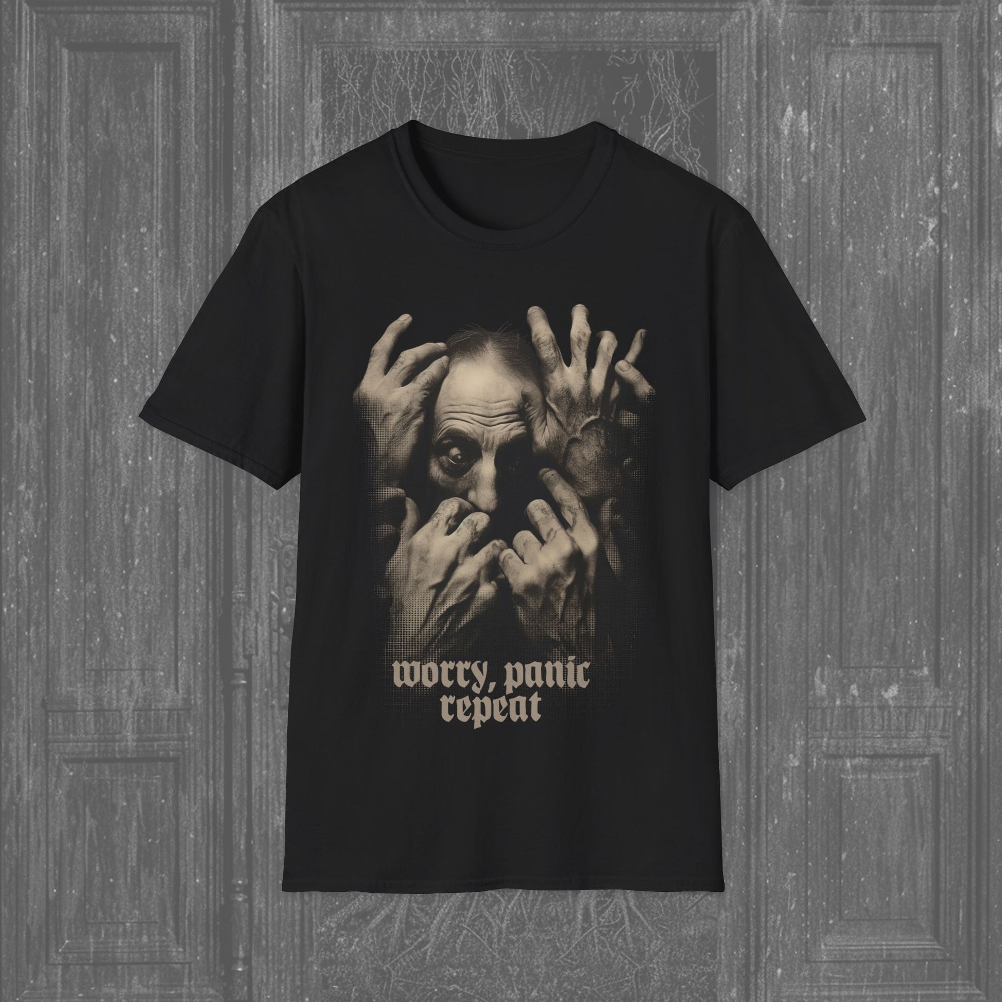 Black creepy t-shirt featuring a man clutching his face in despair, with the text 'Worry, Panic, Repeat' beneath. A haunting design perfect for dark, gothic fashion